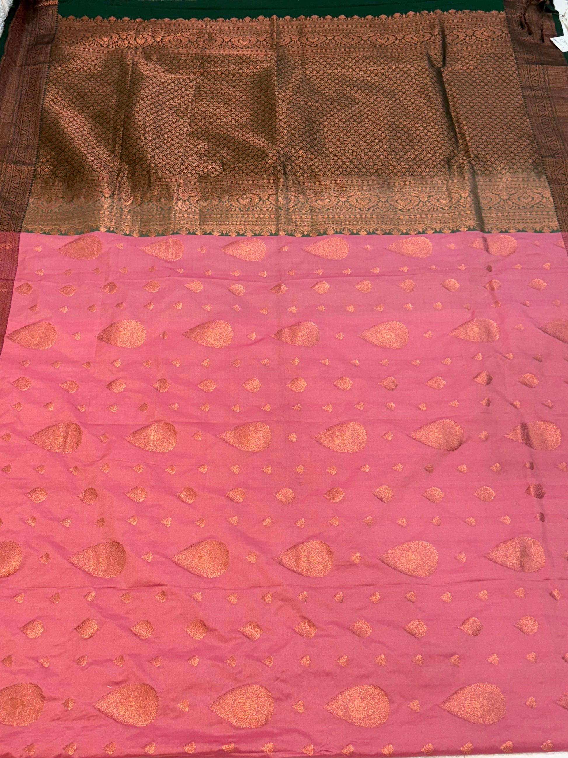 Name: Pink Silk Saree
Fabric: Rich silk with intricate zari weaving and contrast golden border and green colour pallu