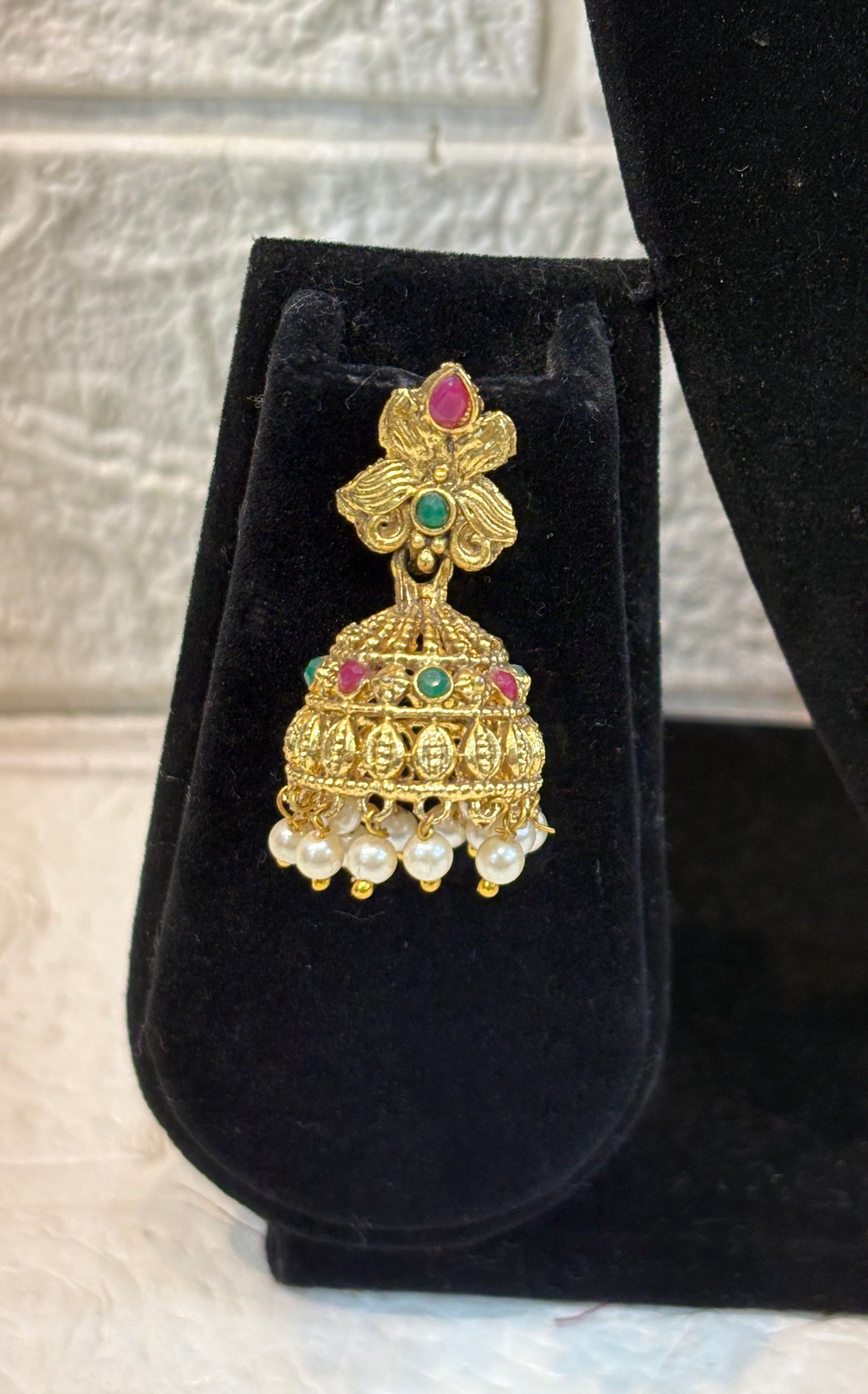 Antique gold-finish temple jewellery featuring intricate Goddess Lakshmi pendants, ruby-green stone detailing, and pearl drops—ideal for weddings and festive w