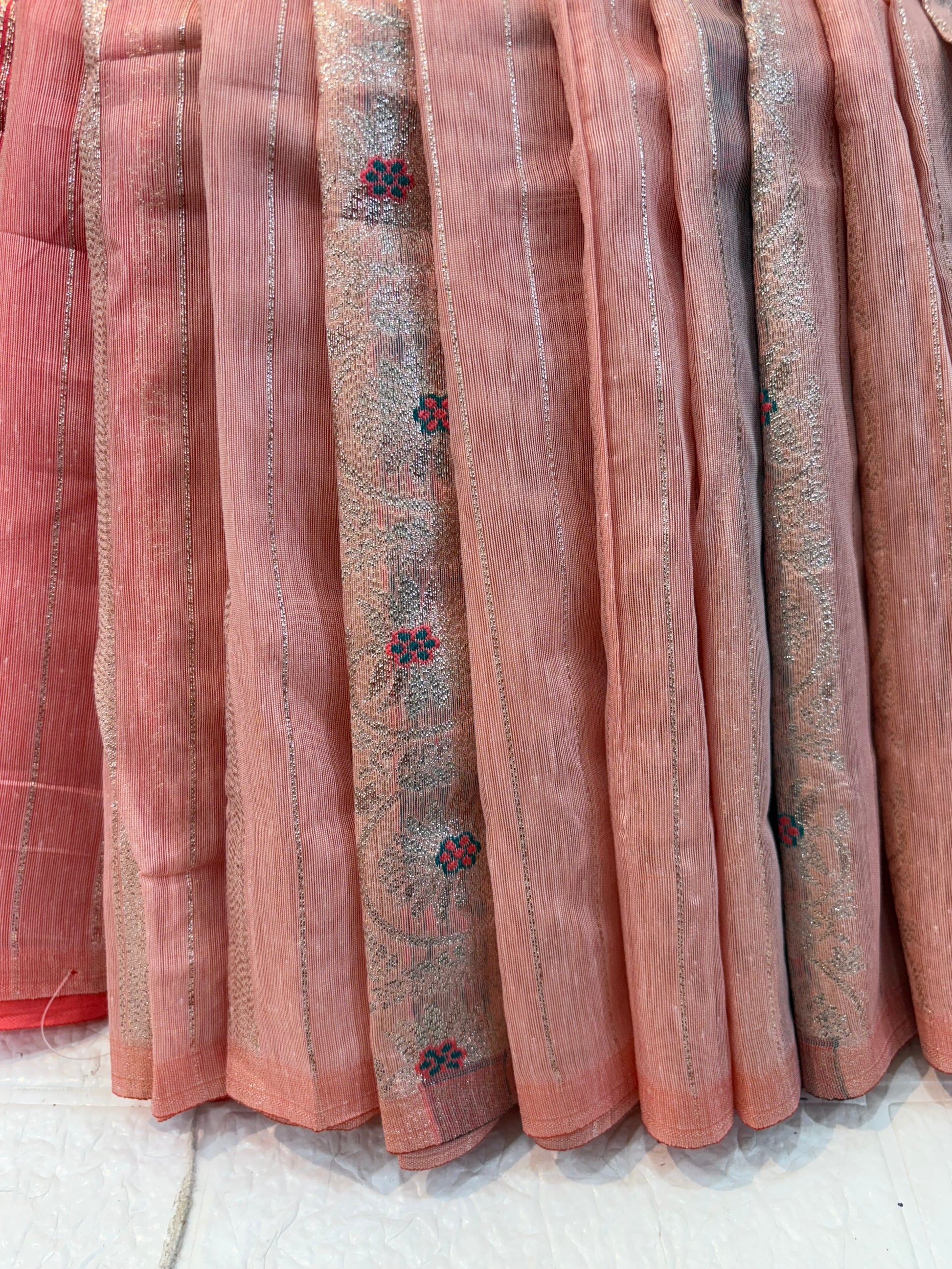 Peach Zari Grace Soft cotton saree with shimmering zari stripes, tiny floral motifs, and a rich coral-toned woven zari border for an elegant festive look.
