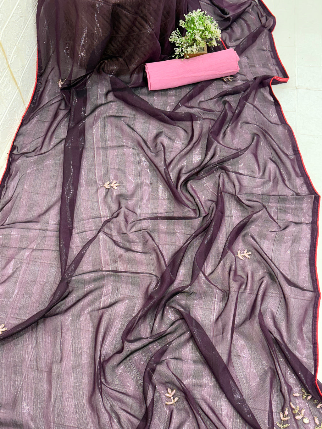 The saree is a Dark Purple Striped Saree with lightweight organza or georgette saree Floral Embroidery.and blouse light pink colour