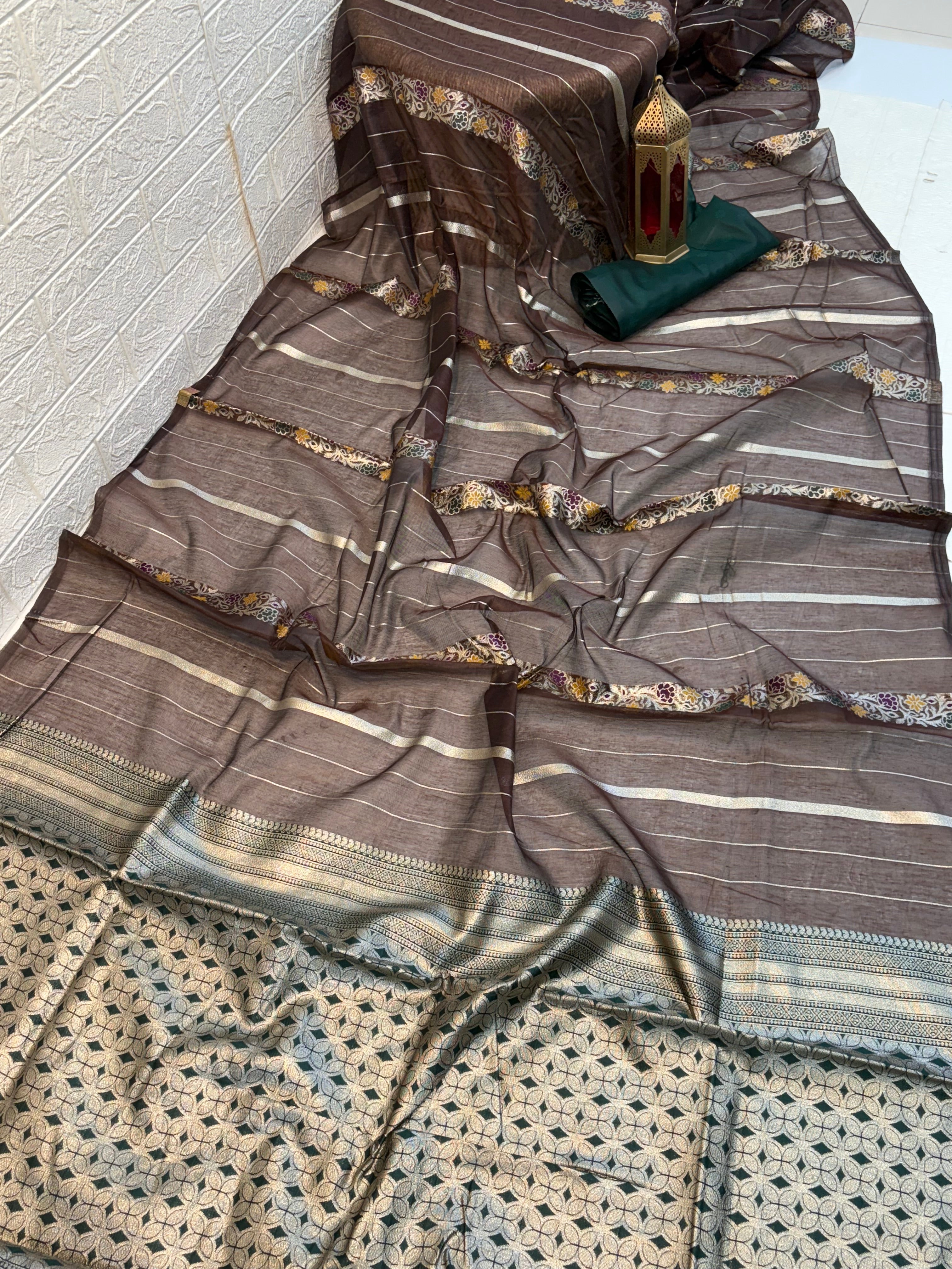 Dark brown zari Elegance Premium soft cotton saree with subtle zari stripes, floral butti accents, and a richly woven antique gold zari pallu and border for a classic, graceful look.