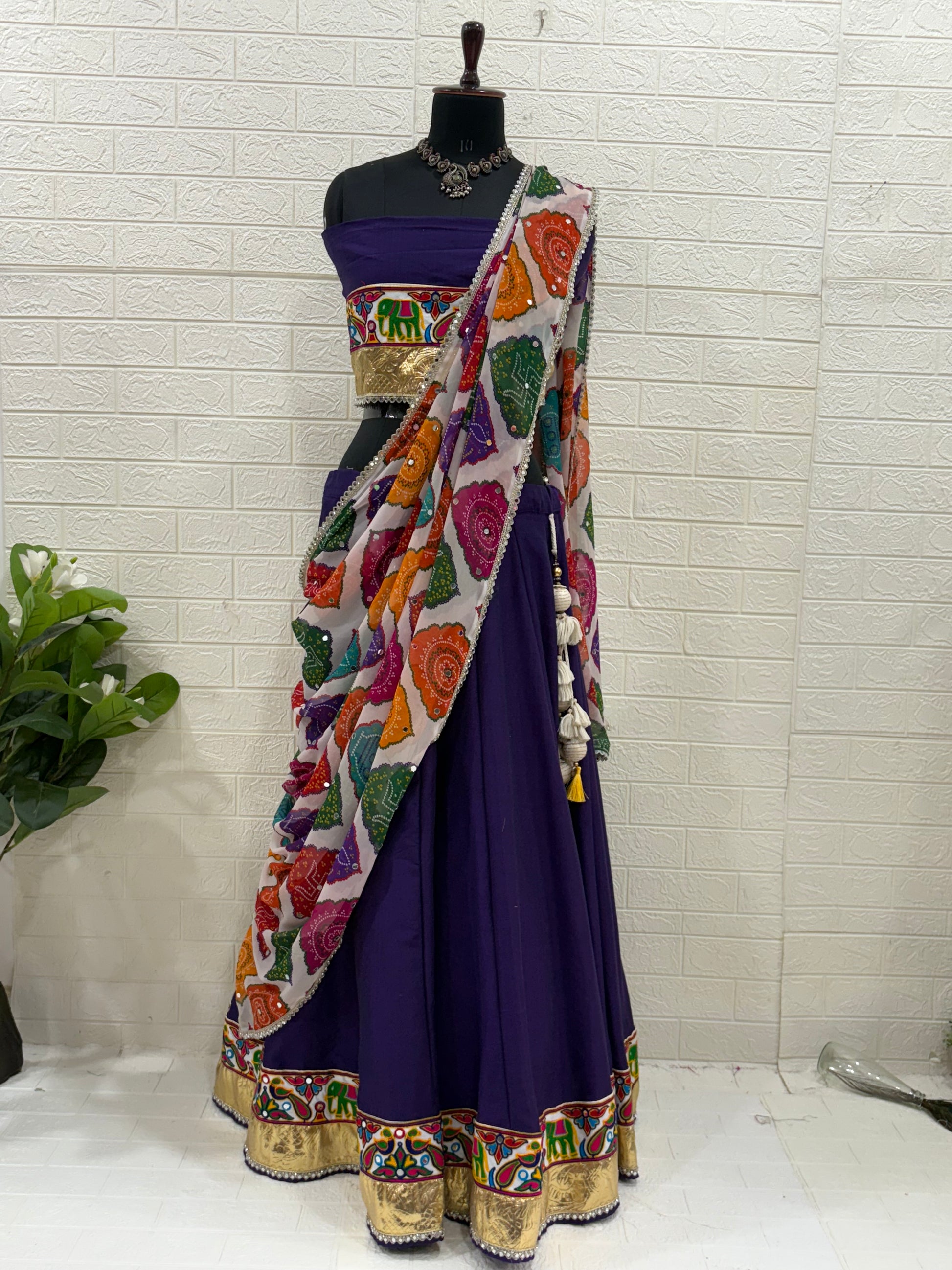 Name:
Purple Navratri Ghaghra Choli Crafted in soft cotton with a vibrant embroidered choli and colorful bandhani dupatta, this ghaghra is perfect for Garba nights and festive celebrations.