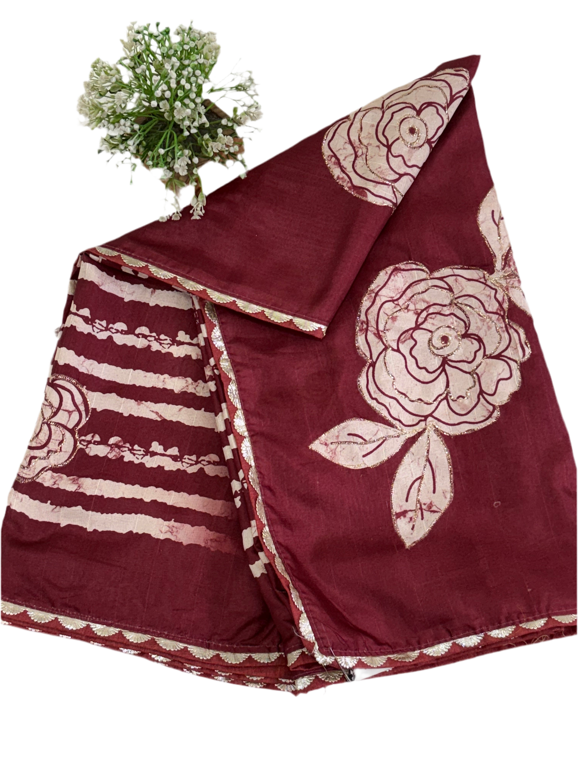 Name: Batik Print Saree/Fabric
Fabric: Typically Cotton or Cotton Silk Blend, sometimes Crepe or Silk, featuring a maroon and off-white wax-resist (Batik) print with rose and stripe motifs.