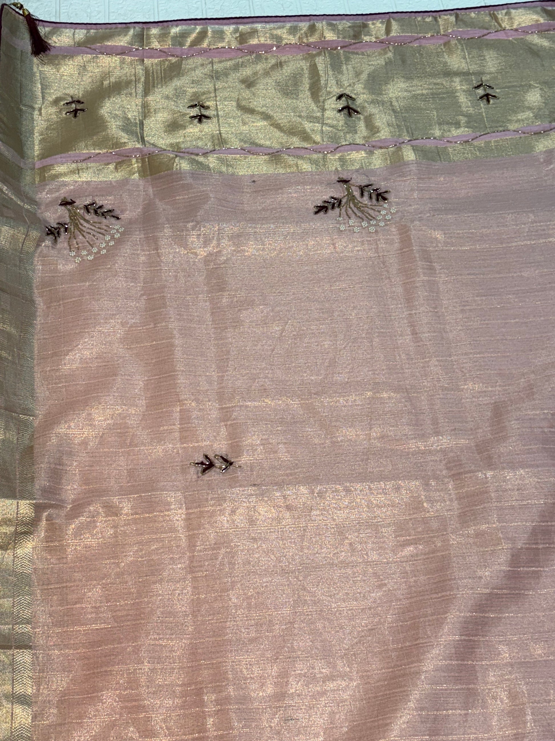 Name: Soft Pastel Pink cotton  shimmering tissue silk fabric 
with delicate zari border and subtle hand-embroidered motifs