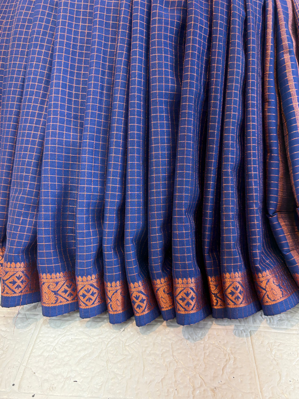 Name: Navy Blue Checkered Handloom Saree soft silk with Zari Border This saree features fine golden check patterns on a deep navy blue base, complemented by a traditional zari-woven border, giving it a rich and elegant handloom appeal.