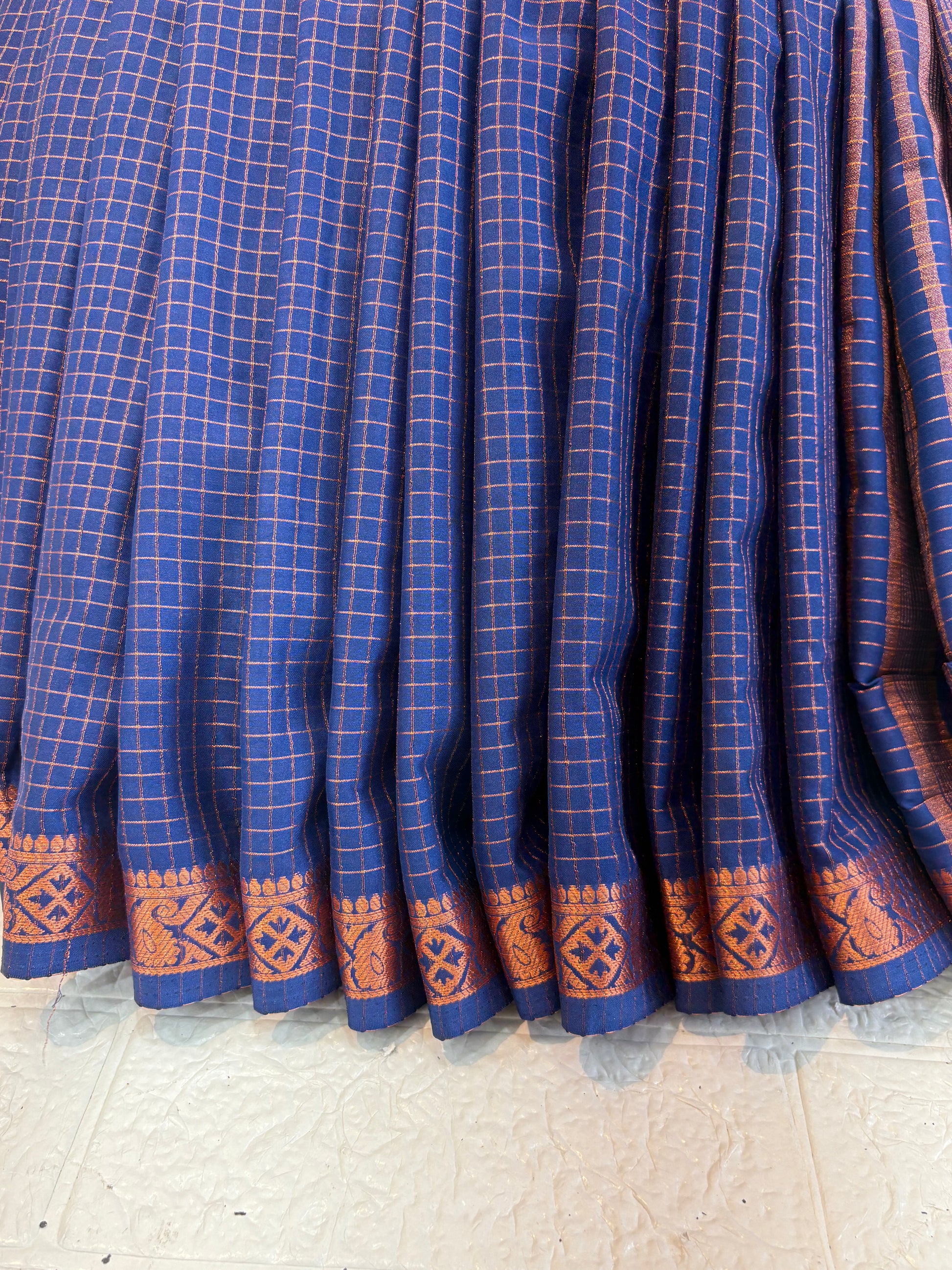 Name: Navy Blue Checkered Handloom Saree soft silk with Zari Border This saree features fine golden check patterns on a deep navy blue base, complemented by a traditional zari-woven border, giving it a rich and elegant handloom appeal.