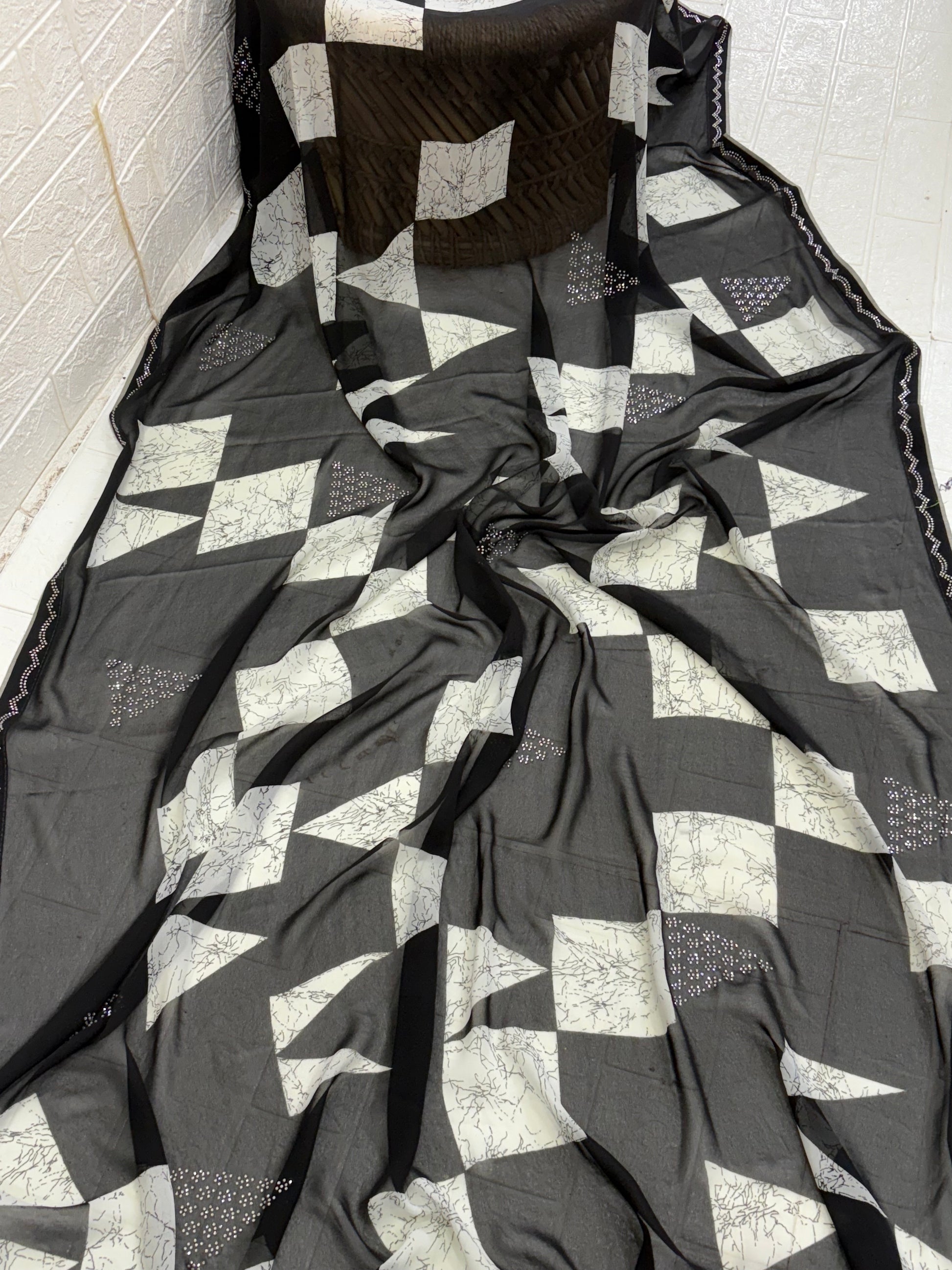 Name: Monochrome Geo Saree fabric pure georgette blend featuring geometric block patterns and subtle sequin accents for a chic contemporary look.