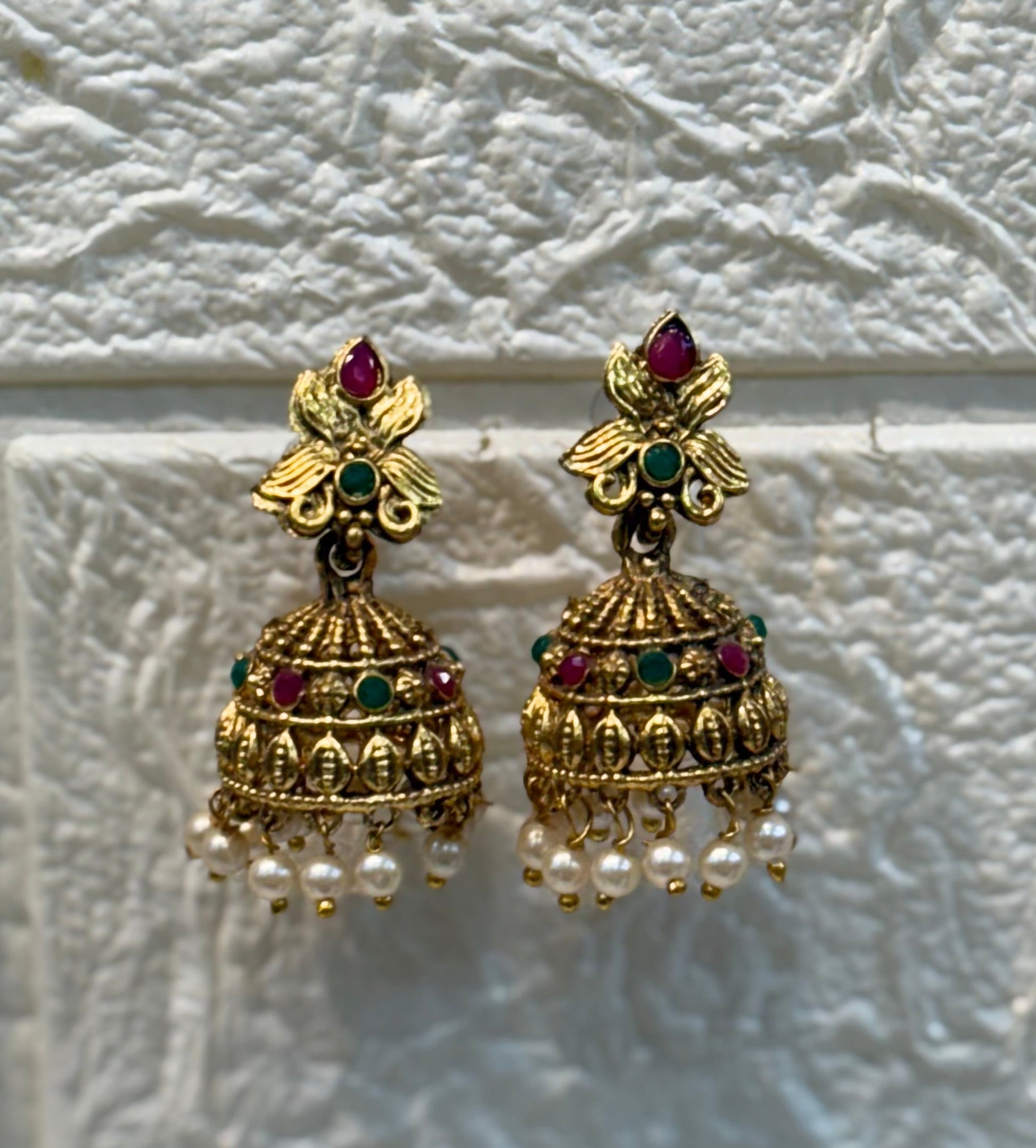 Antique gold-finish temple jewellery featuring intricate Goddess Lakshmi pendants, ruby-green stone detailing, and pearl drops—ideal for weddings and festive w