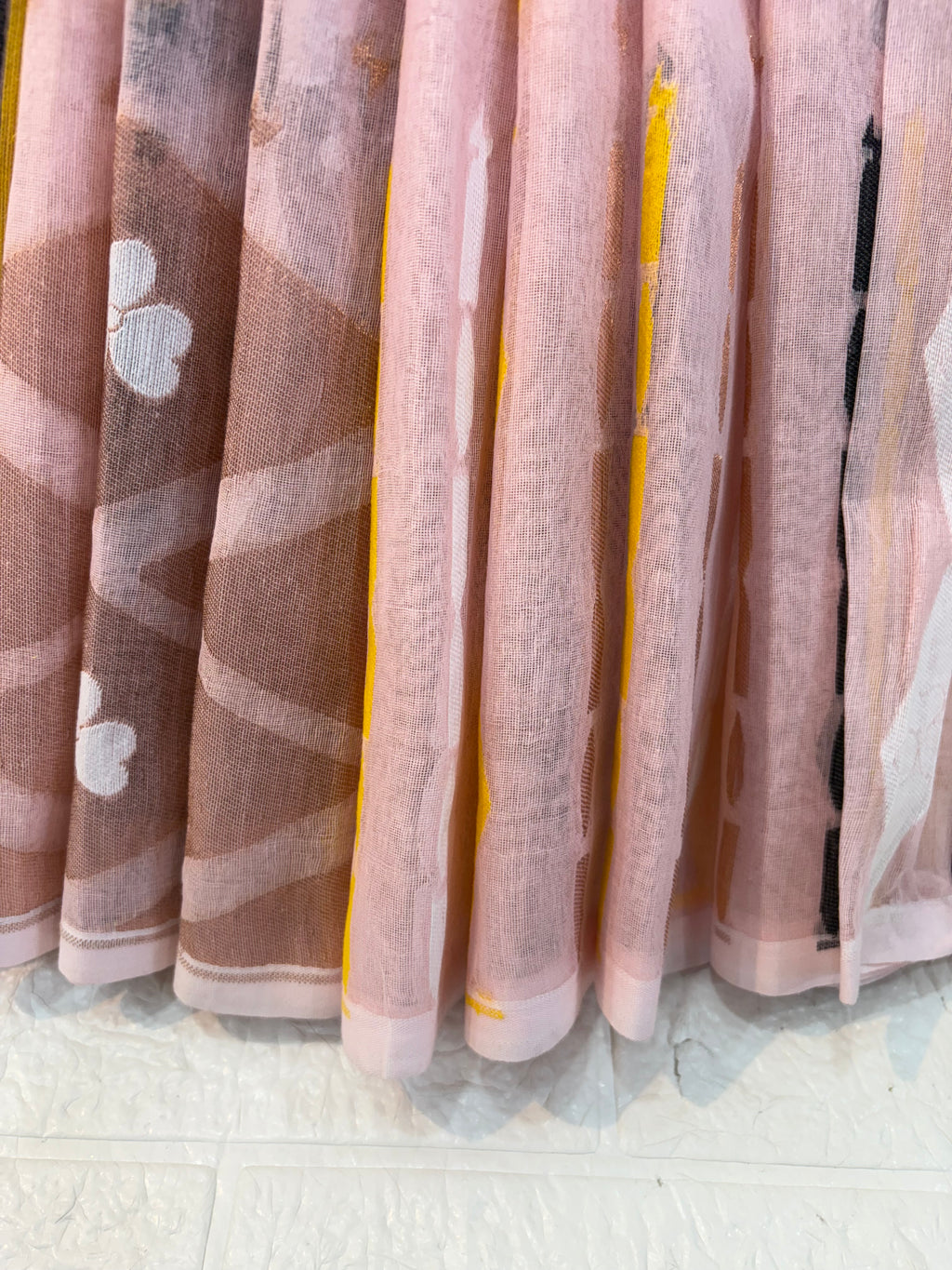 Pastel light pink Jamdani Saree cotton Jamdani, featuring geometric diamond motifs with delicate floral buttas and a soft, airy handwoven texture