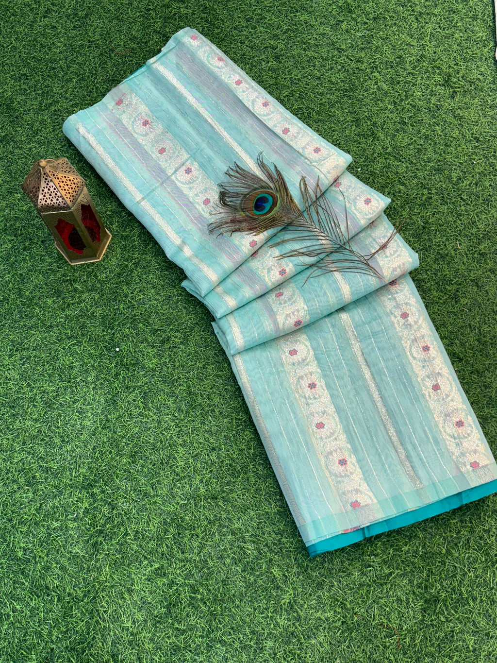 Zari Bloom Elegant sky blue soft cotton saree with soft zari stripes, delicate floral butti work, and a richly woven teal zari border for a refined festive look.