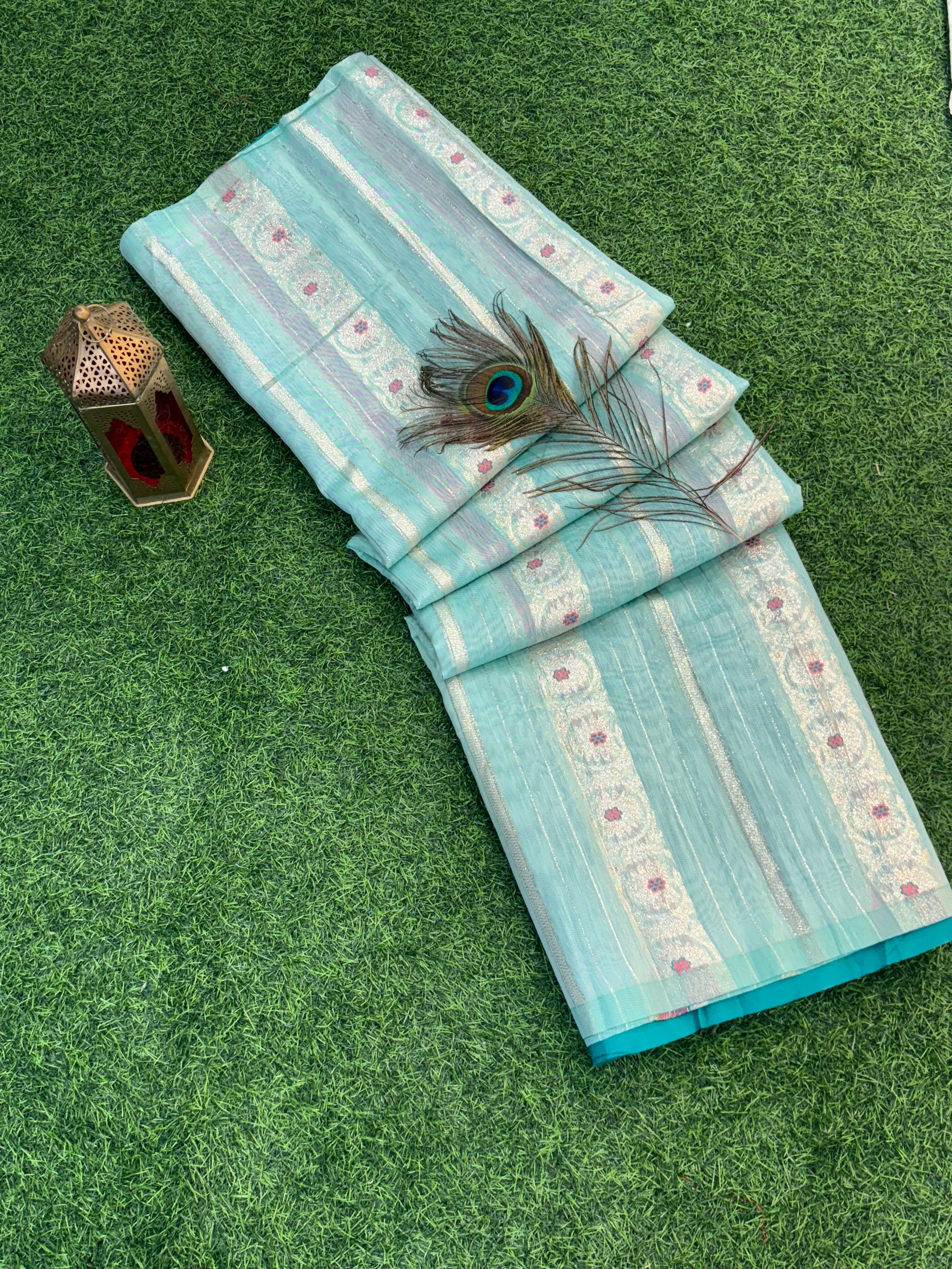 Zari Bloom Elegant sky blue soft cotton saree with soft zari stripes, delicate floral butti work, and a richly woven teal zari border for a refined festive look.