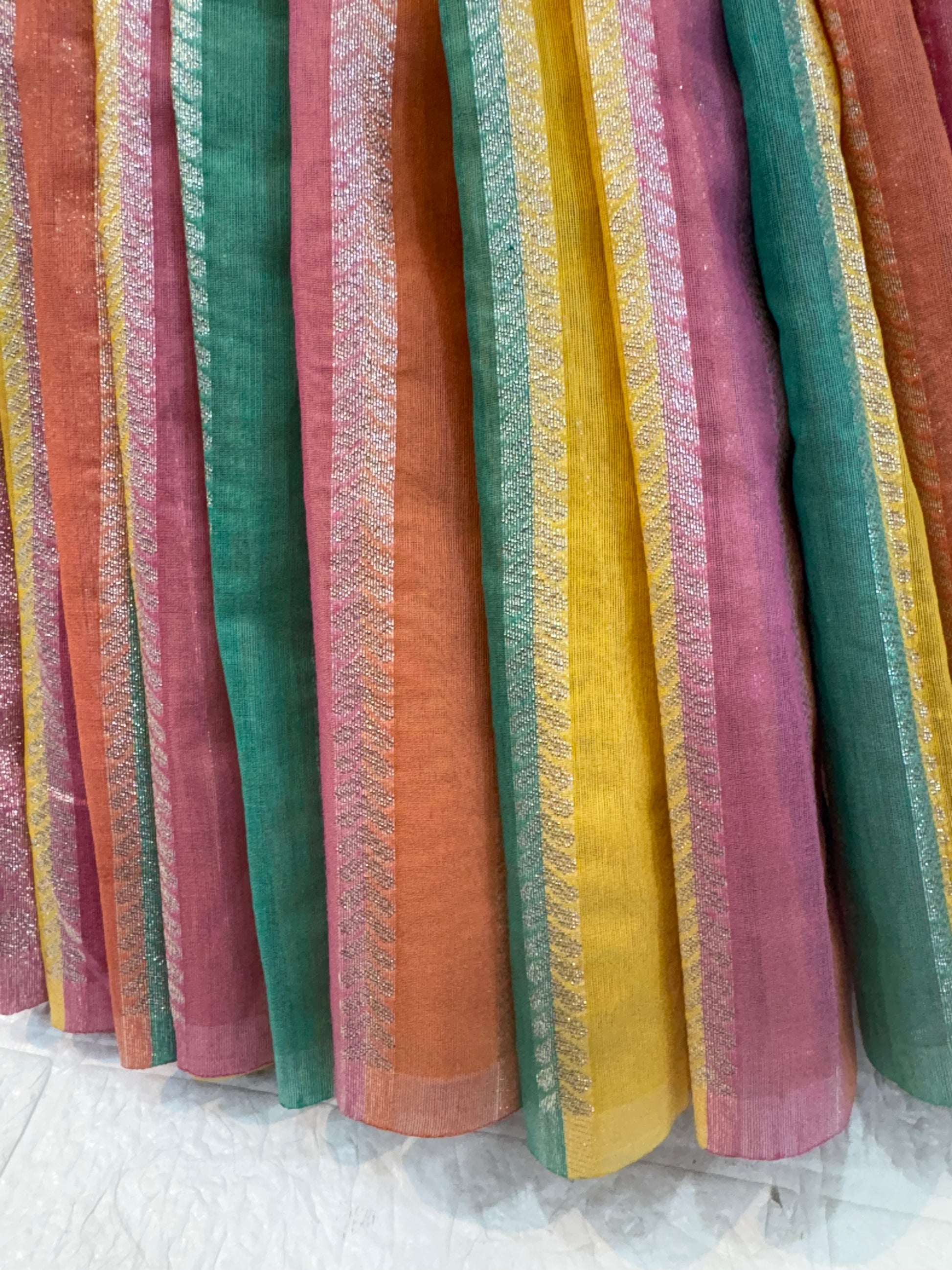 Rainbow Pastel Zari Stripe
Lightweight soft cotton saree with vibrant multicolor zari stripes and a soft pink richly woven zari border, perfect for festive and daytime occasions.