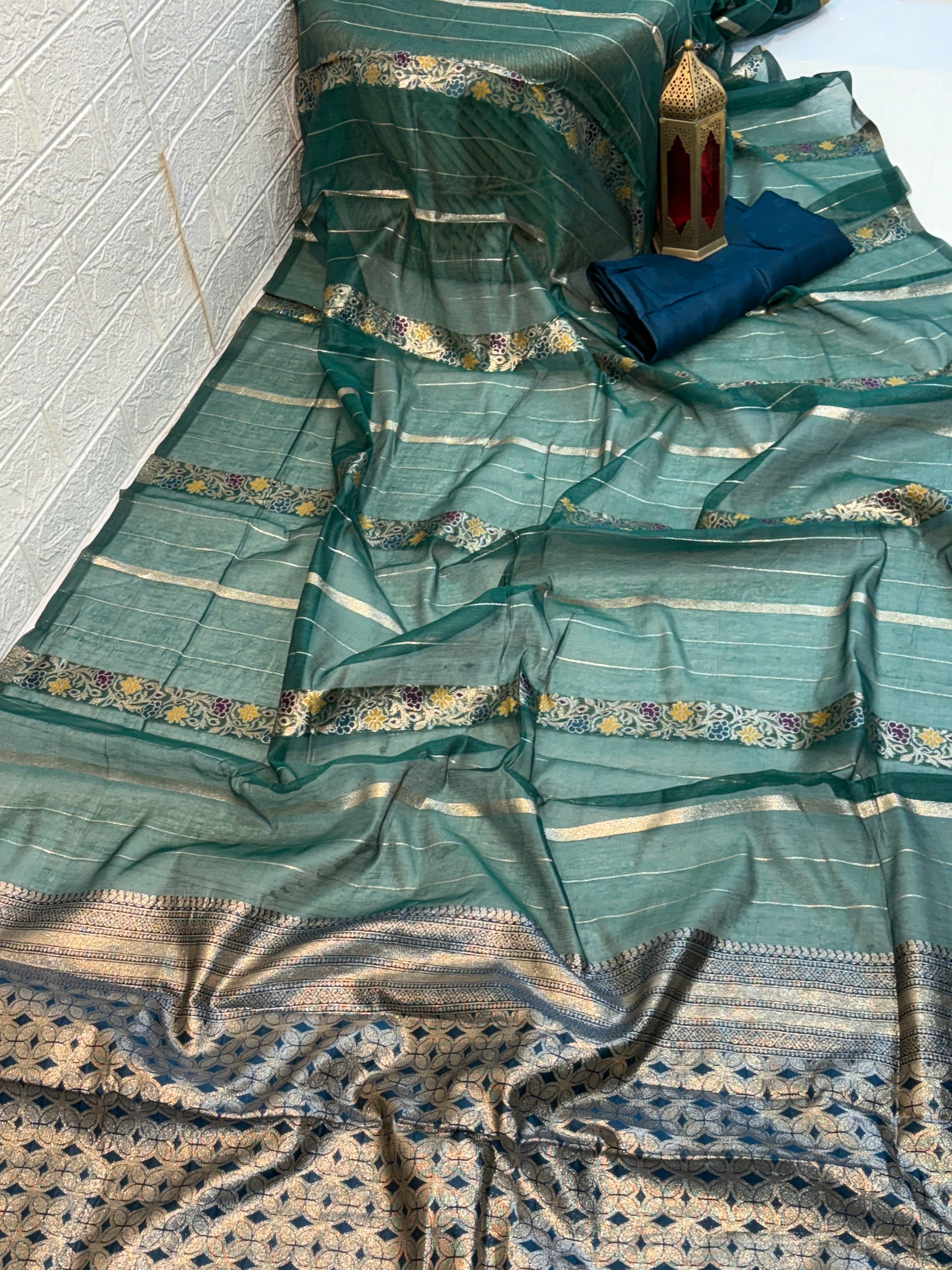 Teal green Garden Zari Classic Lightweight soft cotton saree featuring fine zari stripes, floral motif accents, and an elegant richly woven zari pallu and border.