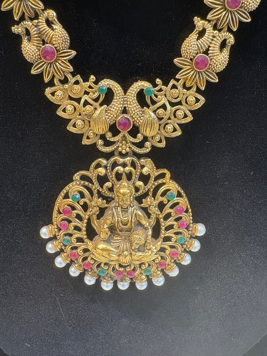 Traditional South Indian temple jewellery featuring Goddess Lakshmi motifs, floral links, and pearl drops—perfect for weddings, festive occasions, and classical saree looks.