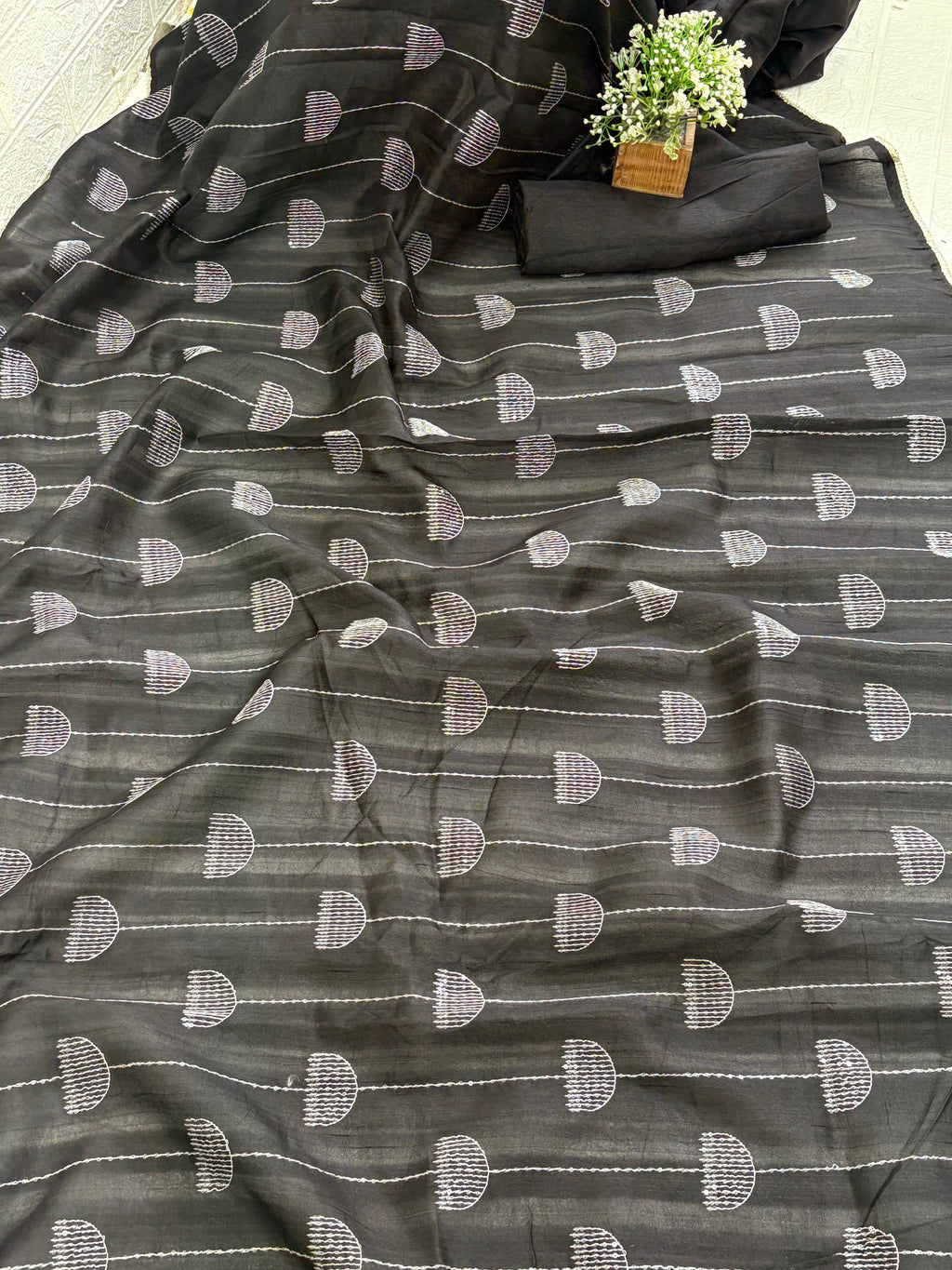 Name: Chanderi or Cotton Silk Saree The texture and slight sheen indicate a Chanderi or Cotton Silk Blend. With blouse The design features woven Zari lines/stripes and small thread/Aari embroidery motifs.