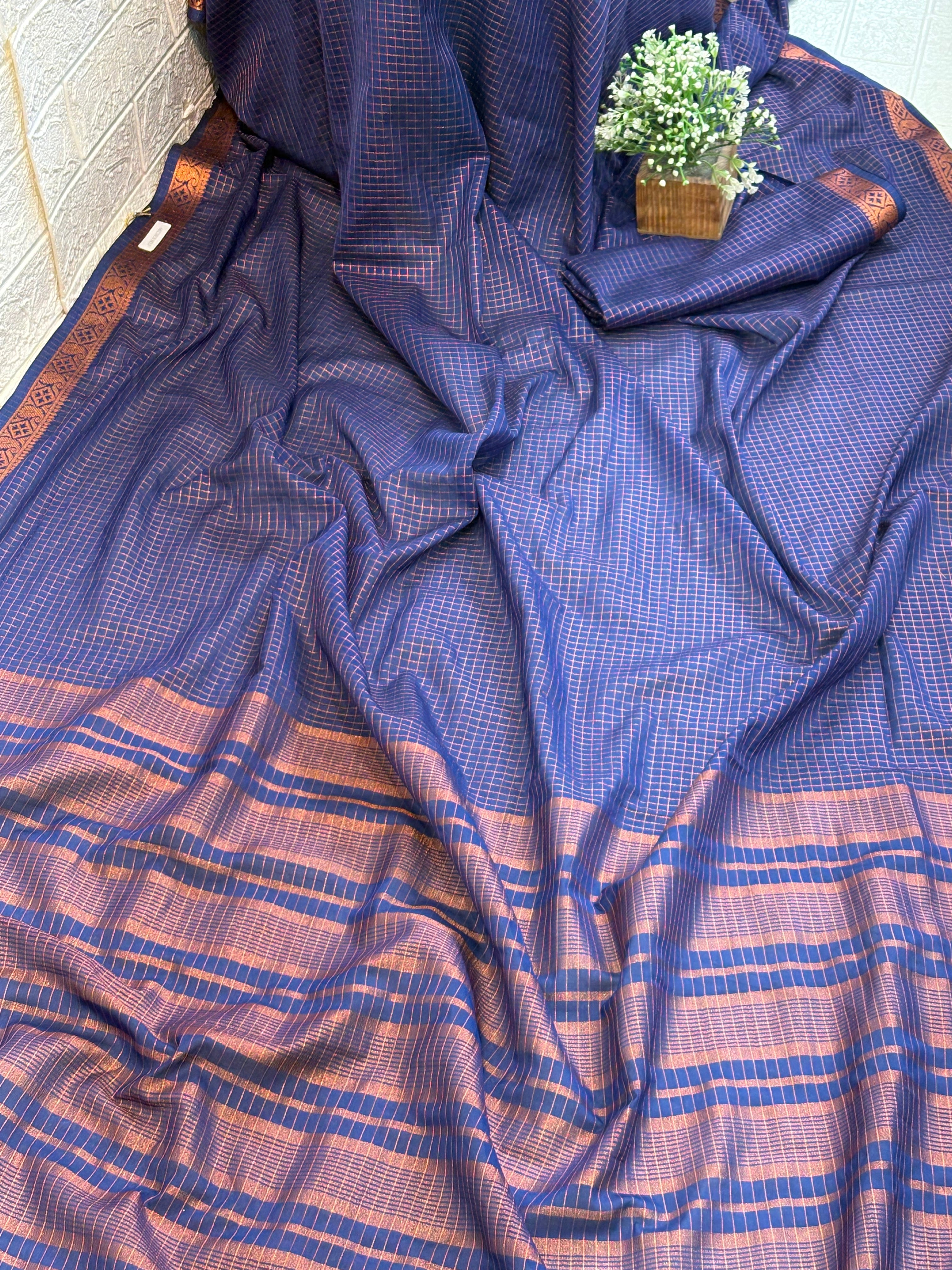 Name: Navy Blue Checkered Handloom Saree soft silk with Zari Border This saree features fine golden check patterns on a deep navy blue base, complemented by a traditional zari-woven border, giving it a rich and elegant handloom appeal.