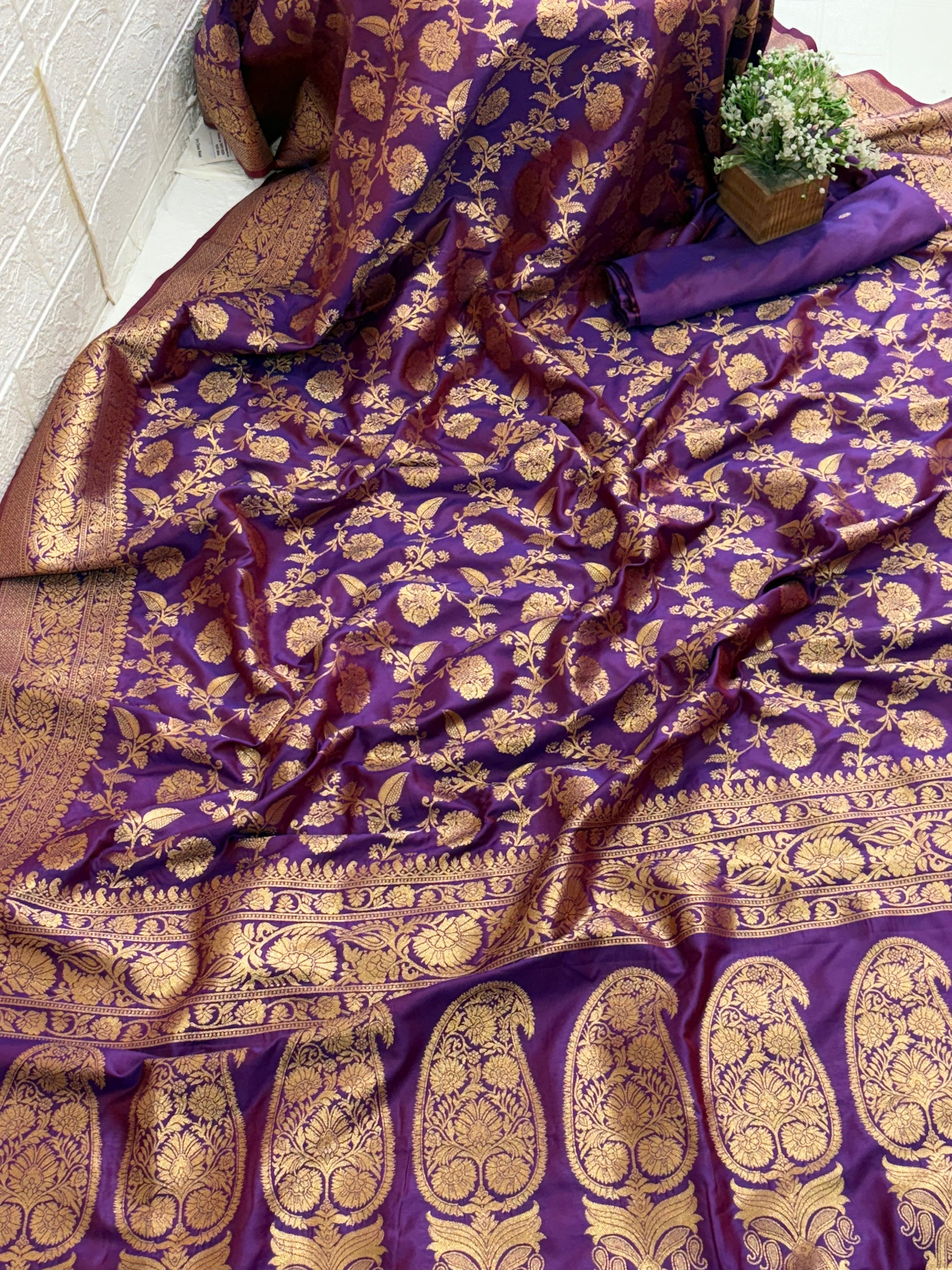 Name: Patola-Style or Kanchipuram Checked Silk Saree purple colour with golden work featuring a woven geometric check and floral zari work.