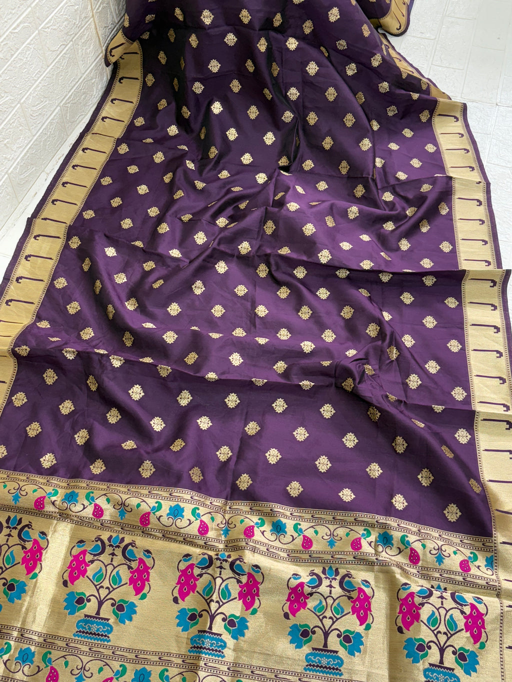 Name: Mystic Plum Banarasi Silk Dupatta 
Crafted from luxurious Banarasi silk, this dupatta features golden zari motifs all over with a contrast beige border adorned with vibrant peacock and floral patterns in teal and