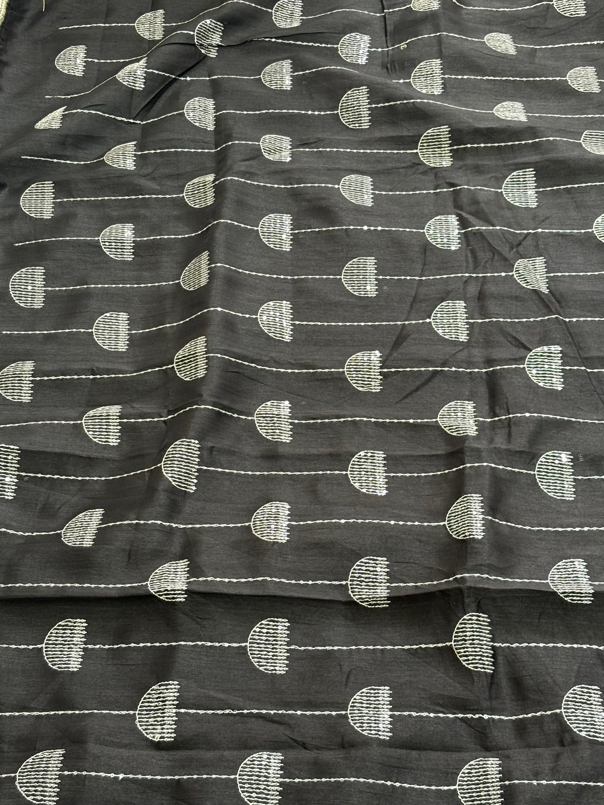 Name: Chanderi or Cotton Silk Saree The texture and slight sheen indicate a Chanderi or Cotton Silk Blend. With blouse The design features woven Zari lines/stripes and small thread/Aari embroidery motifs.