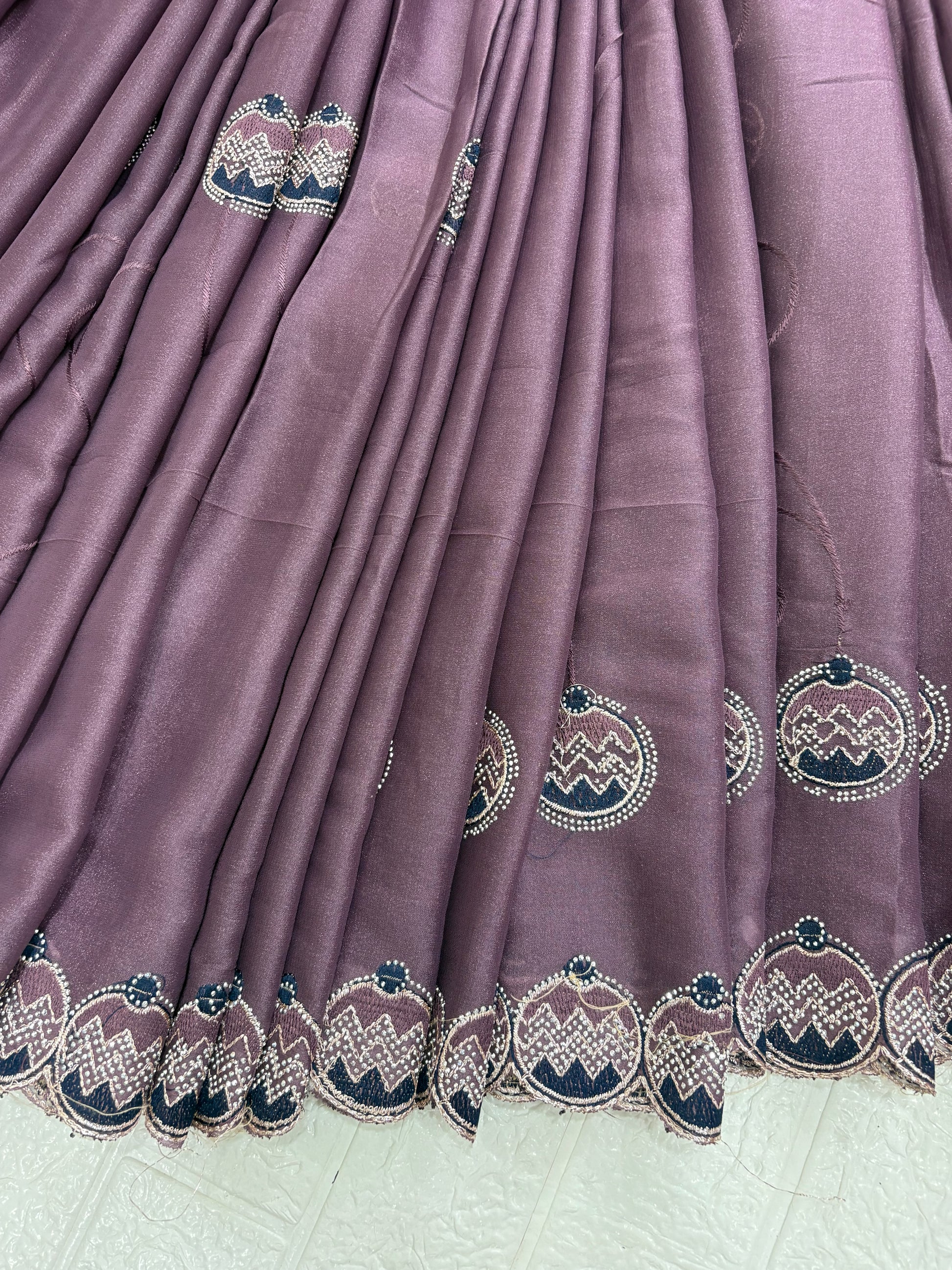 Saree Purple Embroidered Saree with purple mauve and georgette or organza Medallion Butti and Scalloped Border. It is a sheer saree with scattered embroidery and stonework.