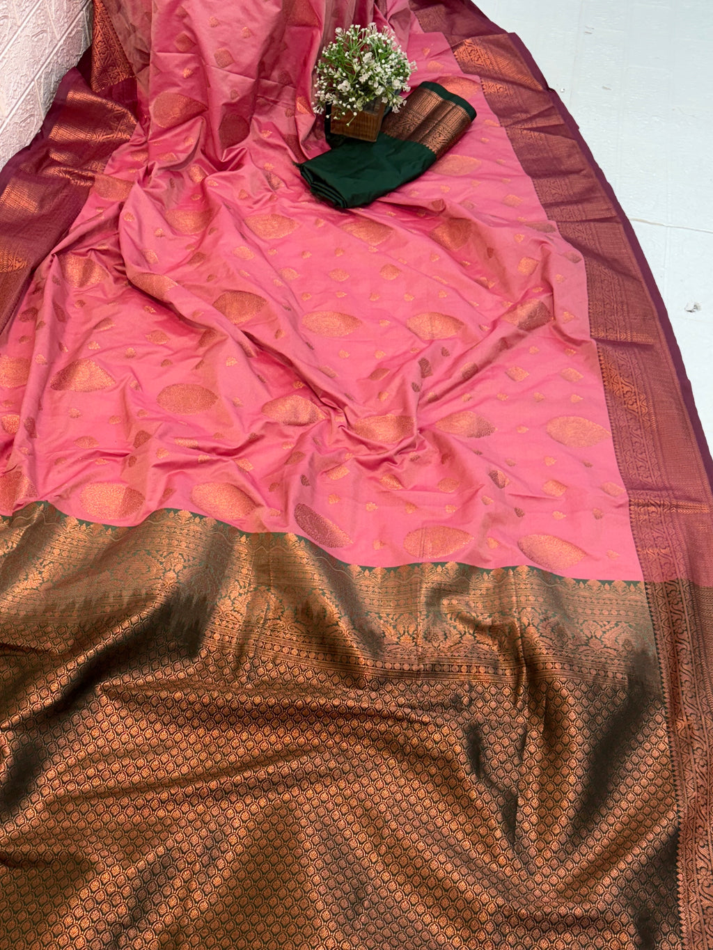 Name: Pink Silk Saree
Fabric: Rich silk with intricate zari weaving and contrast golden border and green colour pallu