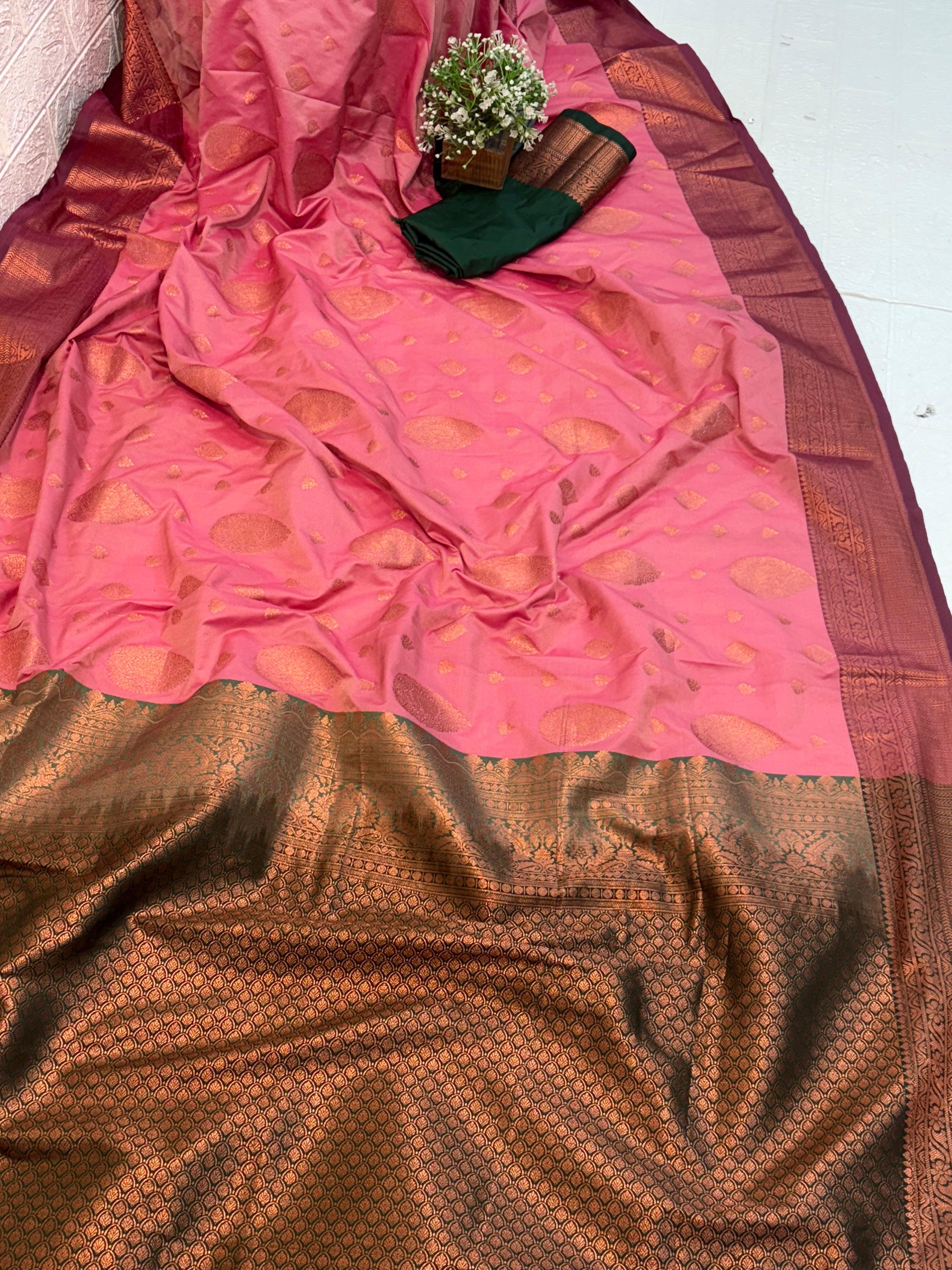 Name: Pink Silk Saree
Fabric: Rich silk with intricate zari weaving and contrast golden border and green colour pallu