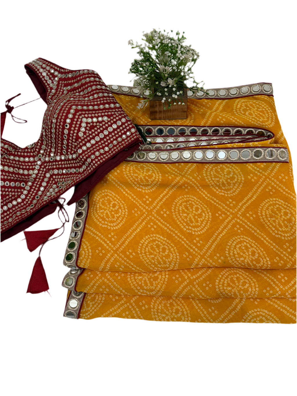 Bandhani print fabric crepe silk yellow colour saree blend with traditional tie-dye pattern and mirror-work maroon blouse embellishment