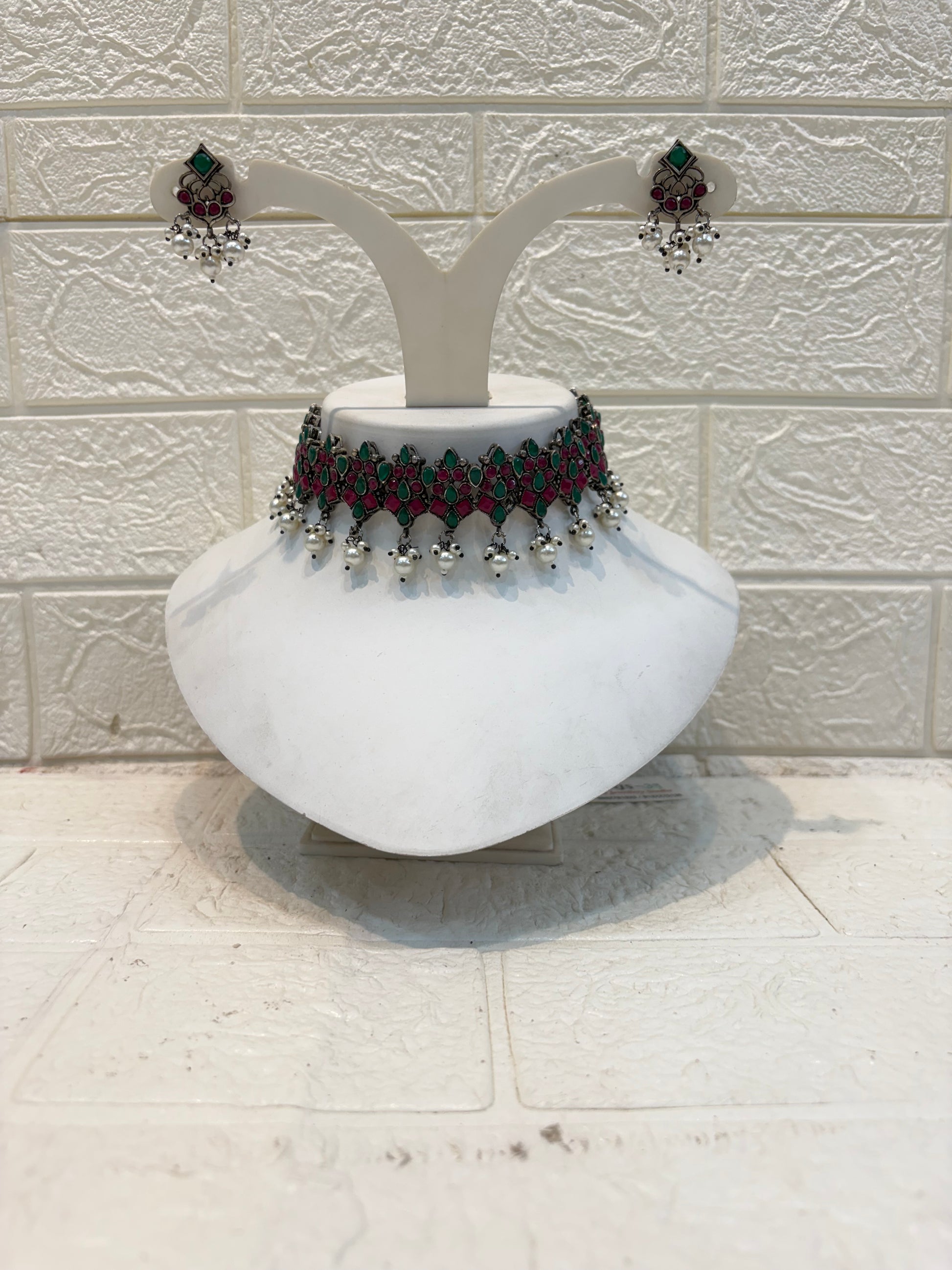 Name: Traditional Kundan Choker Necklace Set Oxidized silver metal with red-green stone inlay and silver bead drops