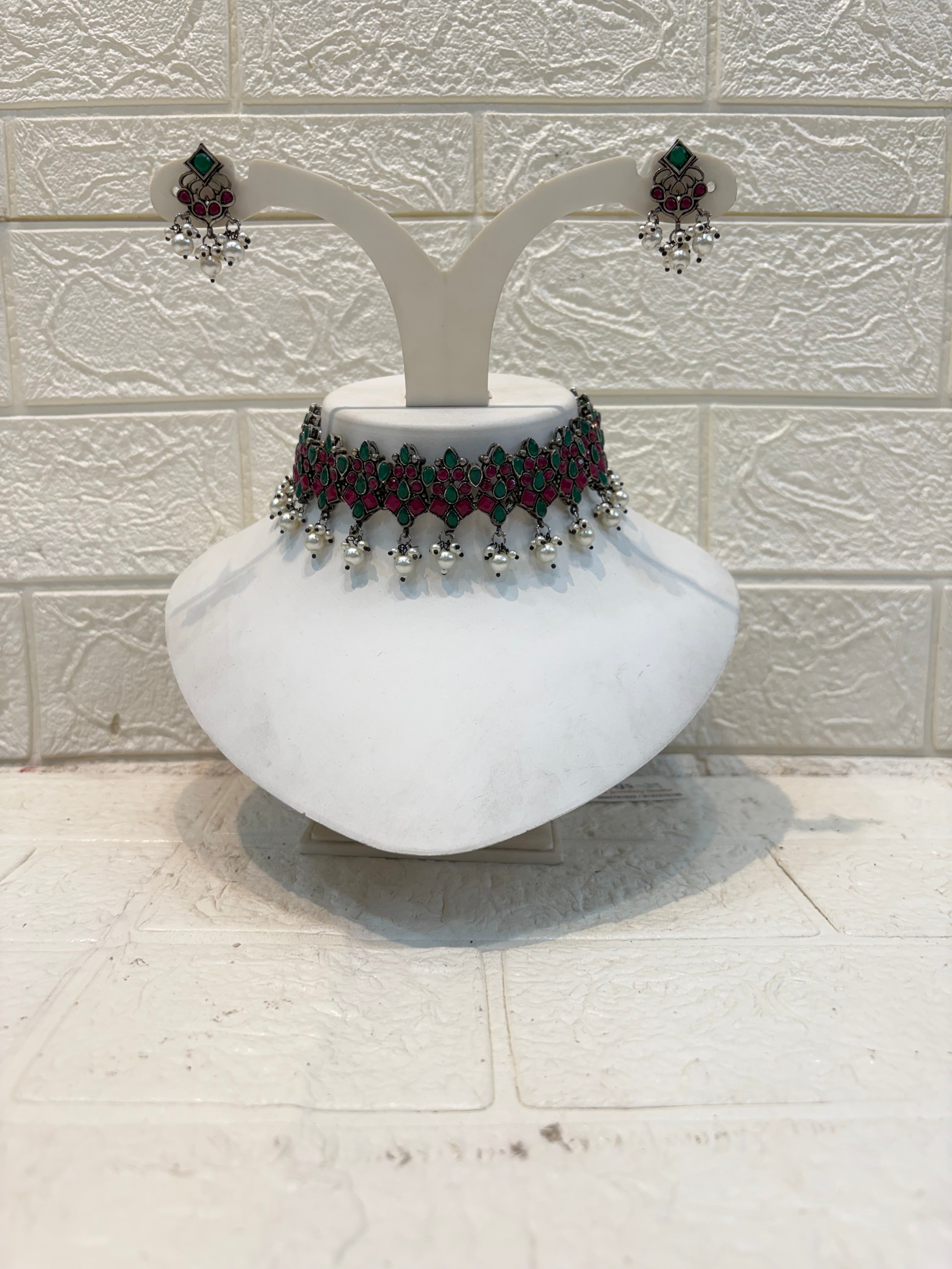 Name: Traditional Kundan Choker Necklace Set Oxidized silver metal with red-green stone inlay and silver bead drops