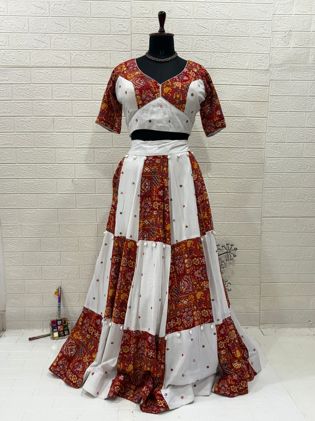 Name:
Rust & Ivory Ajrakh Lehenga Handcrafted soft cotton  lehenga with cowrie shell in rust ajrakh and ivory panels, paired with a matching White dupatta with playful perfect for a vibrant Navratri look.